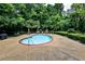 Outdoor community pool surrounded by lush greenery and comfortable seating at 214 Ridley Howard Ct, Decatur, GA 30030