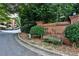 Community signage for The Ridley Howard House surrounded by lush landscaping and mature trees at 214 Ridley Howard Ct, Decatur, GA 30030