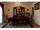 Formal dining room with a large china cabinet, chandelier, and elegant table setting at 5700 Thrasher Ln, Conyers, GA 30094