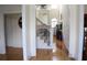 Foyer with hardwood floors, staircase, and entryways to other rooms. Elegant and bright at 5700 Thrasher Ln, Conyers, GA 30094