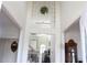 Bright and airy foyer with staircase, and view into the living area with high ceilings at 5700 Thrasher Ln, Conyers, GA 30094