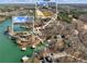 Aerial view of waterfront home, boat dock and the surrounding area at 6041 Blackberry Ln, Buford, GA 30518