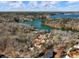 Stunning aerial view of the lakeside property with lush greenery, and serene water views at 6041 Blackberry Ln, Buford, GA 30518