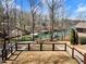 Lake view backyard with a firepit, patio area, and a pathway to the water; perfect for enjoying the outdoors at 6041 Blackberry Ln, Buford, GA 30518