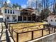 Expansive backyard features a well-manicured lawn, a covered patio, and a fenced area for privacy at 6041 Blackberry Ln, Buford, GA 30518