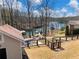 Scenic backyard featuring a fenced yard, fire pit, and lake views, perfect for outdoor enjoyment and entertaining at 6041 Blackberry Ln, Buford, GA 30518