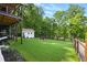Beautifully manicured backyard with lush green grass and mature trees at 6041 Blackberry Ln, Buford, GA 30518