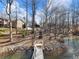 The backyard has a wooden walkway from the house down to the lake, surrounded by trees and greenery; perfect for nature lovers at 6041 Blackberry Ln, Buford, GA 30518