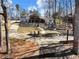 Charming backyard features a well-manicured lawn, a cozy fire pit area, and a spacious deck for outdoor relaxation at 6041 Blackberry Ln, Buford, GA 30518