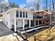 Charming home with large windows, a spacious deck, and a beautiful backyard; perfect for entertaining and relaxation at 6041 Blackberry Ln, Buford, GA 30518