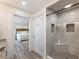 Recently remodeled bathroom with walk-in shower with seat and bedroom access at 6041 Blackberry Ln, Buford, GA 30518