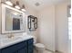 Bathroom has a blue vanity, a shelf and a window for lots of natural light at 6041 Blackberry Ln, Buford, GA 30518