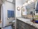 Updated bathroom with granite vanity, tiled shower, custom mirror and grey cabinets at 6041 Blackberry Ln, Buford, GA 30518