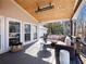 Relaxing covered deck featuring a cozy seating area and a wooden ceiling at 6041 Blackberry Ln, Buford, GA 30518