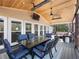 Inviting covered deck with a fire table, ceiling fan, and mounted TV at 6041 Blackberry Ln, Buford, GA 30518