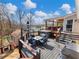 Multi-level deck featuring an outdoor dining area, hot tub, and grill, perfect for entertaining and enjoying lake views at 6041 Blackberry Ln, Buford, GA 30518