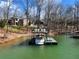 Waterfront home featuring a private boat dock with boat and seating at 6041 Blackberry Ln, Buford, GA 30518