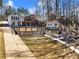 Rear exterior view of home with fenced yard, patio area, and outdoor storage building at 6041 Blackberry Ln, Buford, GA 30518