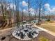 Inviting fire pit area features a circle of Adirondack chairs, perfect for enjoying lakeside evenings at 6041 Blackberry Ln, Buford, GA 30518