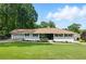 Charming home with lush green lawn, well-maintained landscaping, and classic curb appeal; move-in ready at 6041 Blackberry Ln, Buford, GA 30518