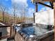 Deck with a hot tub overlooking a scenic lake view at 6041 Blackberry Ln, Buford, GA 30518