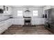Bright kitchen with stainless steel appliances, white cabinets, and subway tile backsplash at 6041 Blackberry Ln, Buford, GA 30518