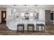 Spacious kitchen featuring a large island with granite countertops and seating for three at 6041 Blackberry Ln, Buford, GA 30518