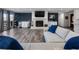 Spacious living room featuring a stone fireplace, wet bar, and hardwood floors at 6041 Blackberry Ln, Buford, GA 30518