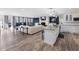 Open-concept kitchen and living room with granite countertops and stainless steel appliances at 6041 Blackberry Ln, Buford, GA 30518