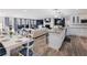 Open-concept living room and kitchen with granite countertops, stainless appliances, and modern décor at 6041 Blackberry Ln, Buford, GA 30518