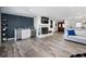 Comfortable living room showcases a stone fireplace, wet bar, and durable floors at 6041 Blackberry Ln, Buford, GA 30518