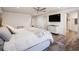 Spacious main bedroom with a ceiling fan, mounted tv, walk-in shower and wood floors at 6041 Blackberry Ln, Buford, GA 30518