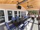 Covered deck with dining and seating areas, overlooking scenic backyard and lake views, ideal for entertaining at 6041 Blackberry Ln, Buford, GA 30518