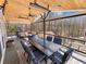 Covered deck with outdoor seating and dining area, perfect for enjoying meals with scenic lake views at 6041 Blackberry Ln, Buford, GA 30518