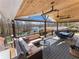 Covered deck with comfortable seating, ceiling fans, and lake views, creating an inviting outdoor living space at 6041 Blackberry Ln, Buford, GA 30518