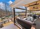 Relaxing covered deck with comfortable seating, dining area, and scenic views, enhancing outdoor living experience at 6041 Blackberry Ln, Buford, GA 30518
