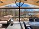 Spacious covered deck with comfortable seating and picturesque lake views, perfect for outdoor living and relaxation at 6041 Blackberry Ln, Buford, GA 30518