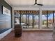 Covered patio with brick flooring and a barrel table offers a view of the lake at 6041 Blackberry Ln, Buford, GA 30518