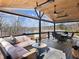 Outdoor patio with ceiling fans and comfortable seating overlooking the lake and backyard at 6041 Blackberry Ln, Buford, GA 30518