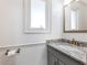 Powder room with a granite countertop, bronze fixtures, and a decorative mirror at 6041 Blackberry Ln, Buford, GA 30518