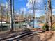 Scenic waterfront view showcasing boat docks nestled between wooded shores at 6041 Blackberry Ln, Buford, GA 30518