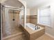 Bright bathroom featuring a walk-in shower and a soaking tub by the window at 7445 Talbot Colony, Atlanta, GA 30328