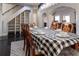 Dining room with seating for six around a table with a checkered tablecloth next to a staircase at 7445 Talbot Colony, Atlanta, GA 30328