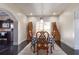 View of the dining room showing a table set for six, modern lighting, and dark hardwood floors at 7445 Talbot Colony, Atlanta, GA 30328