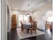 Bright dining room boasts hardwood floors, modern lighting, and an area rug under a table that seats six at 7445 Talbot Colony, Atlanta, GA 30328