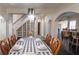Formal dining room includes a set table with seating for six, adjacent to a staircase and living area at 7445 Talbot Colony, Atlanta, GA 30328