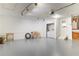 Spacious garage featuring epoxy floors, overhead lighting, and a laundry area at 7445 Talbot Colony, Atlanta, GA 30328