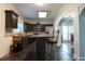 This kitchen has black cabinets, granite countertops, stainless appliances, tile backsplash, and an island with barstool seating at 7445 Talbot Colony, Atlanta, GA 30328