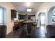 Kitchen features black cabinetry, stainless appliances, tile backsplash, and granite counters, with an adjacent dining area at 7445 Talbot Colony, Atlanta, GA 30328