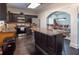 Kitchen view showcases black cabinets, stainless steel appliances, and granite countertops with an island and barstool seating at 7445 Talbot Colony, Atlanta, GA 30328